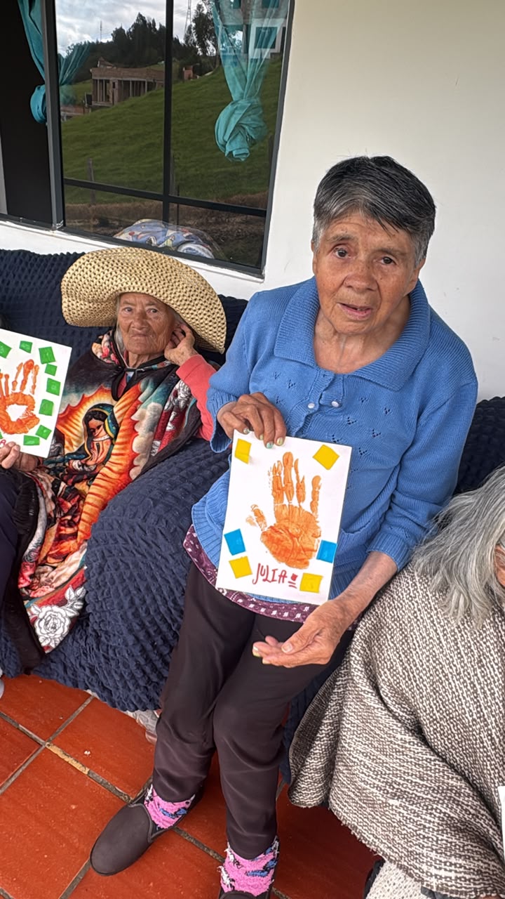 Residentes felices mostrando sus tarjetas de manitas pintadas